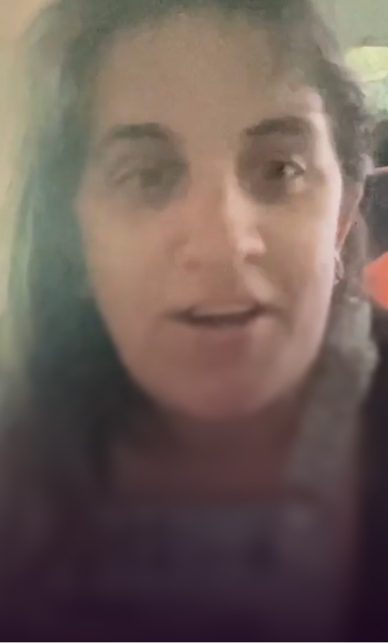 Woman looking at camera giving a Lotus Health AI testimonial